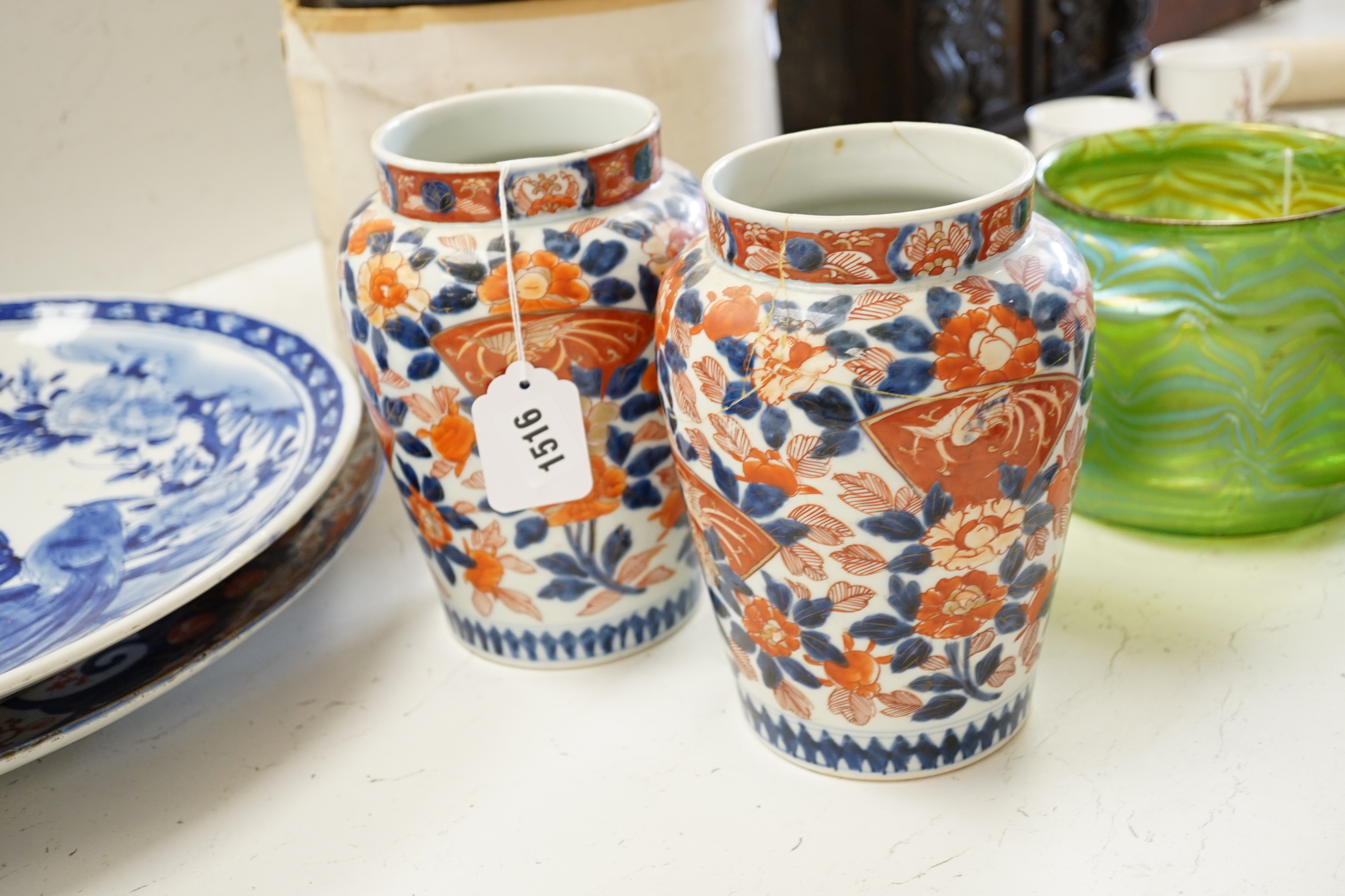 A pair of 19th century Japanese Imari vases, a similar charger, an earlier cracked and riveted charger and a blue and white charger, (5), largest charger 47cm diameter